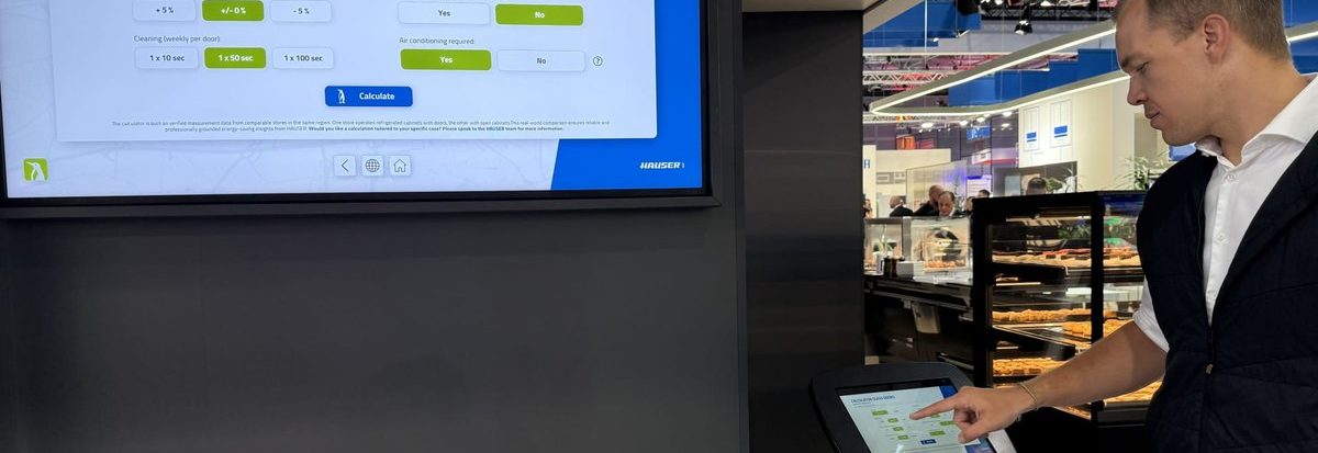 A visitor uses a tablet at the exhibit to control the content on the large screen.